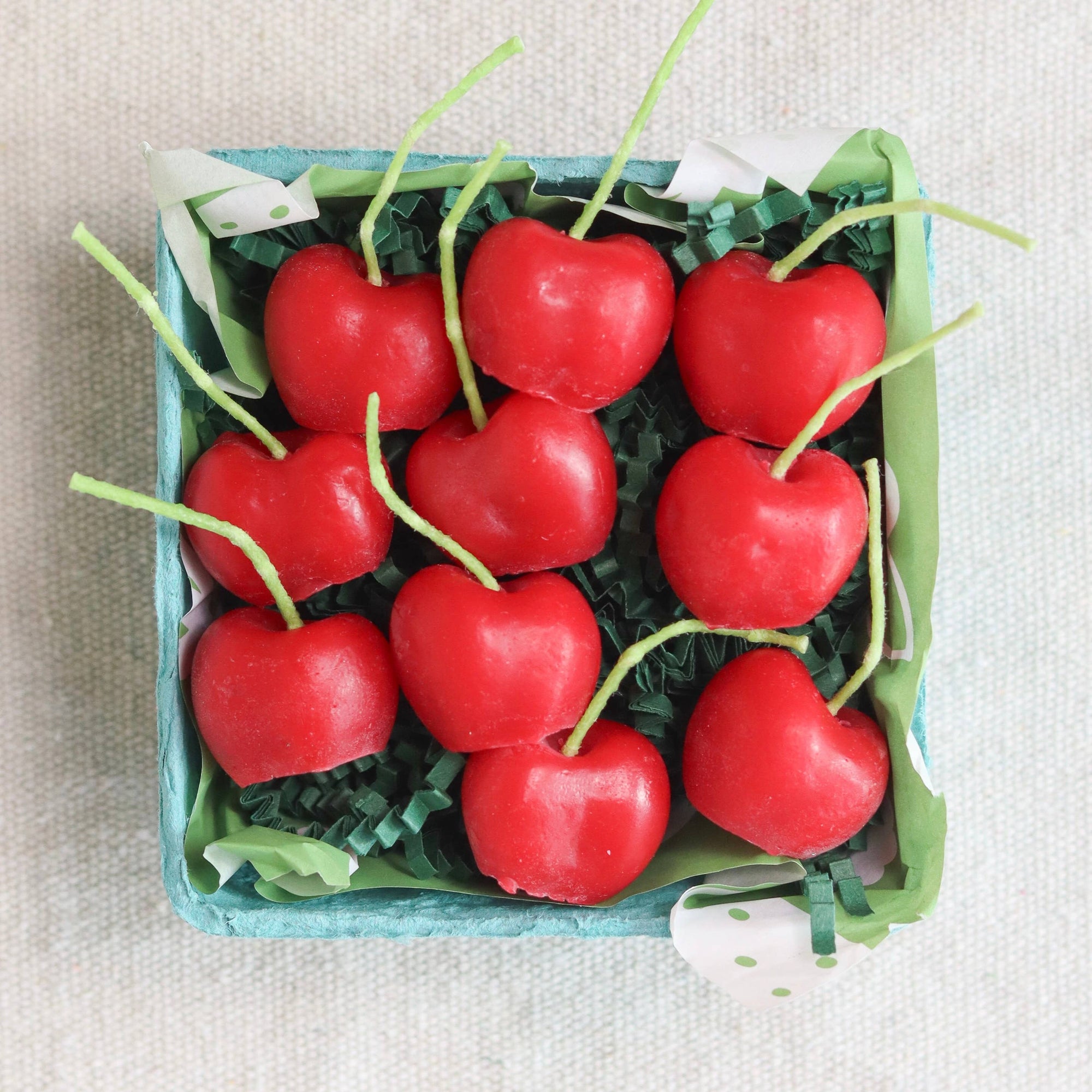 A box of organic cherry candles, made in California by Happy Organics