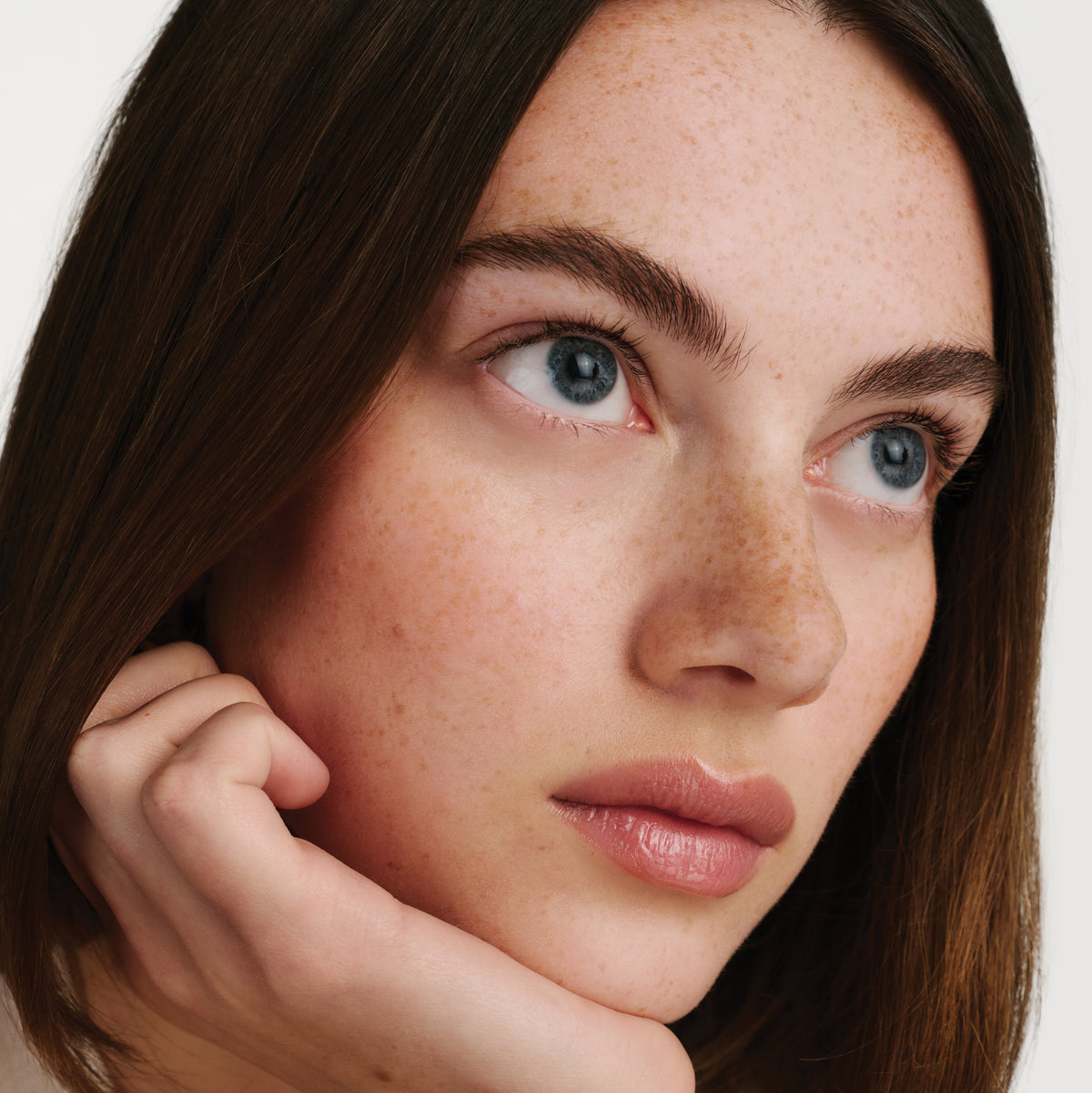 Lipstick with white casing on a light beige background