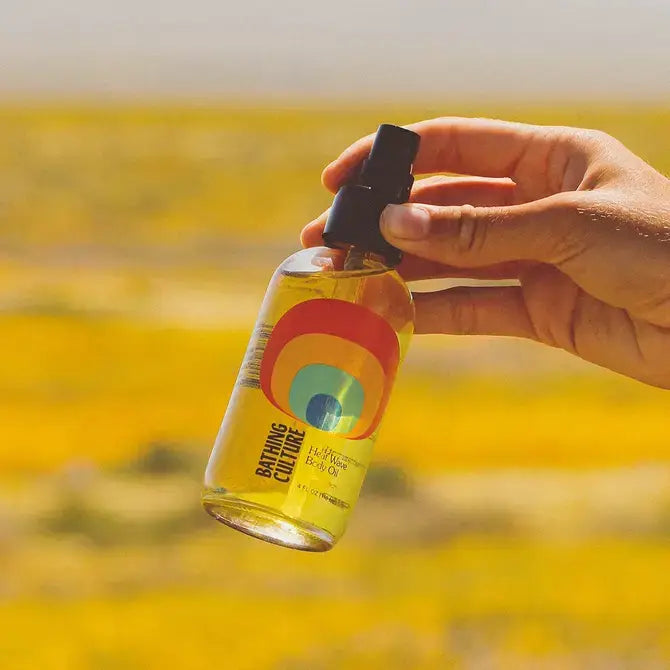 A bottle of heat wave body oil on a natural background.