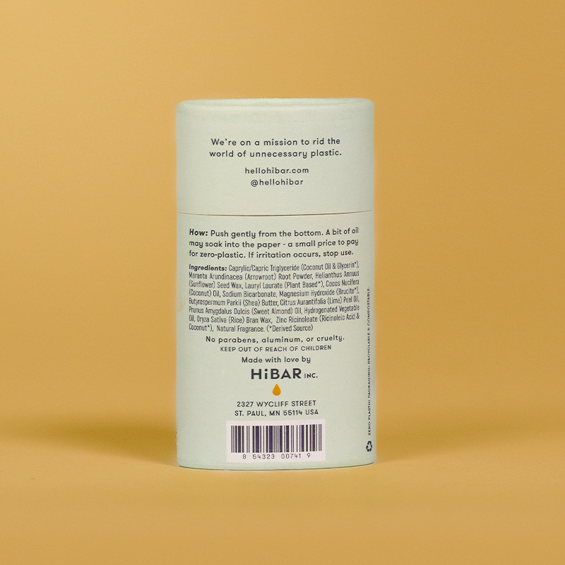 A tube of  hibar bergamot cedar deodorant on an orange background. 