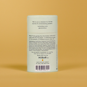 A tube of hibar bergamot cedar deodorant on an orange background. 