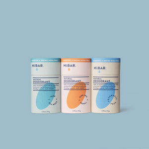 Three hibar deodorants together on a blue background. 