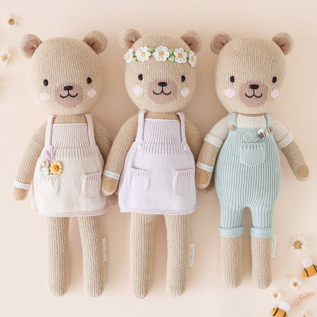 Three honey bear stuffed animals on a beige background. 