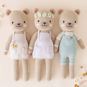 Three honey bear stuffed animals on a beige background. 