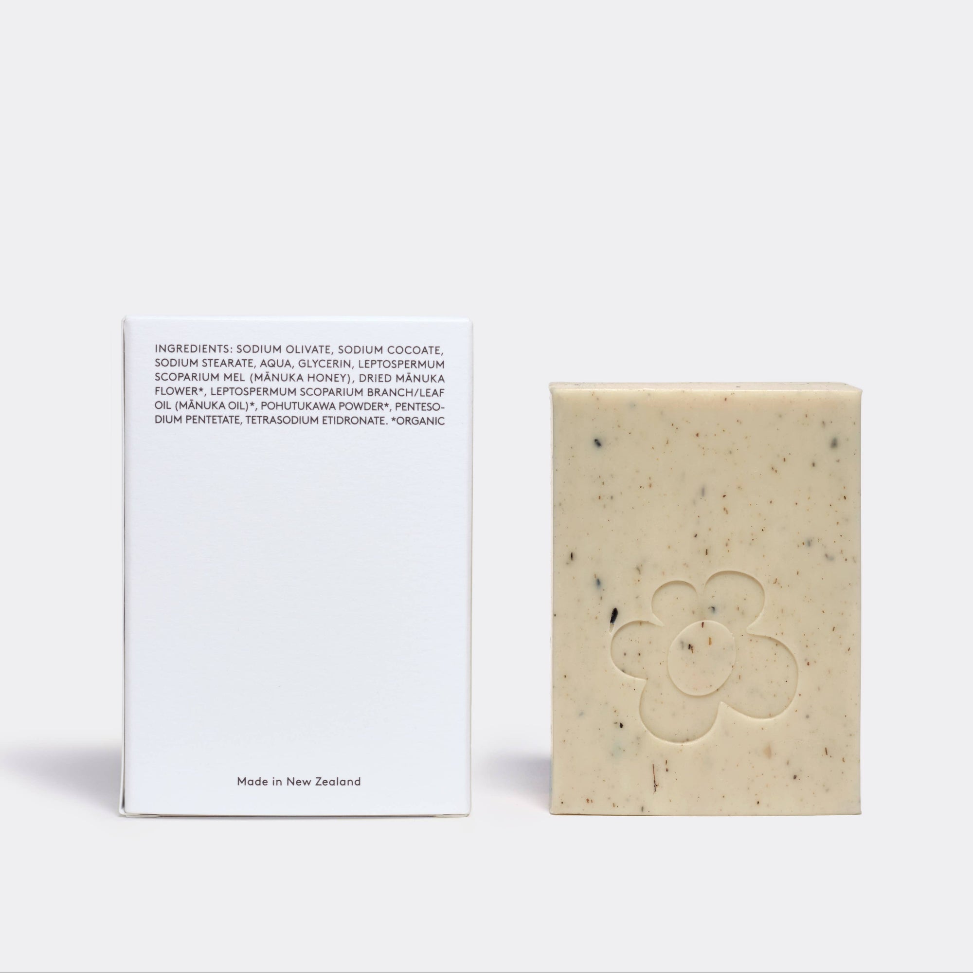 Bar of soap with a white card displaying text on a light gray background