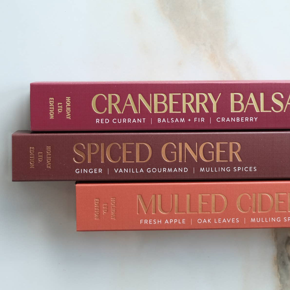 Cranberry Balsam incense sticks with packaging on a marble surface