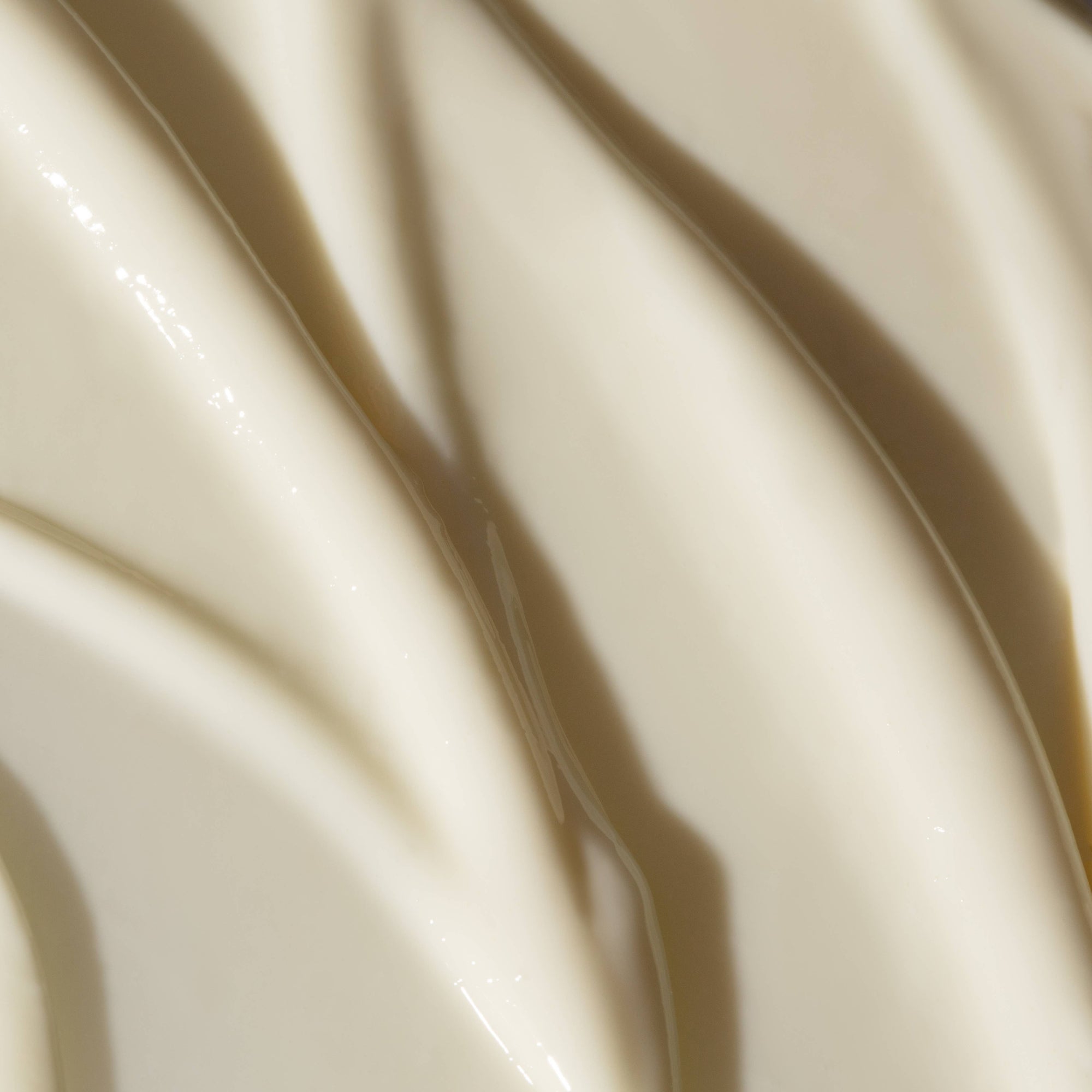 Close-up of smooth, glossy cream color surface.