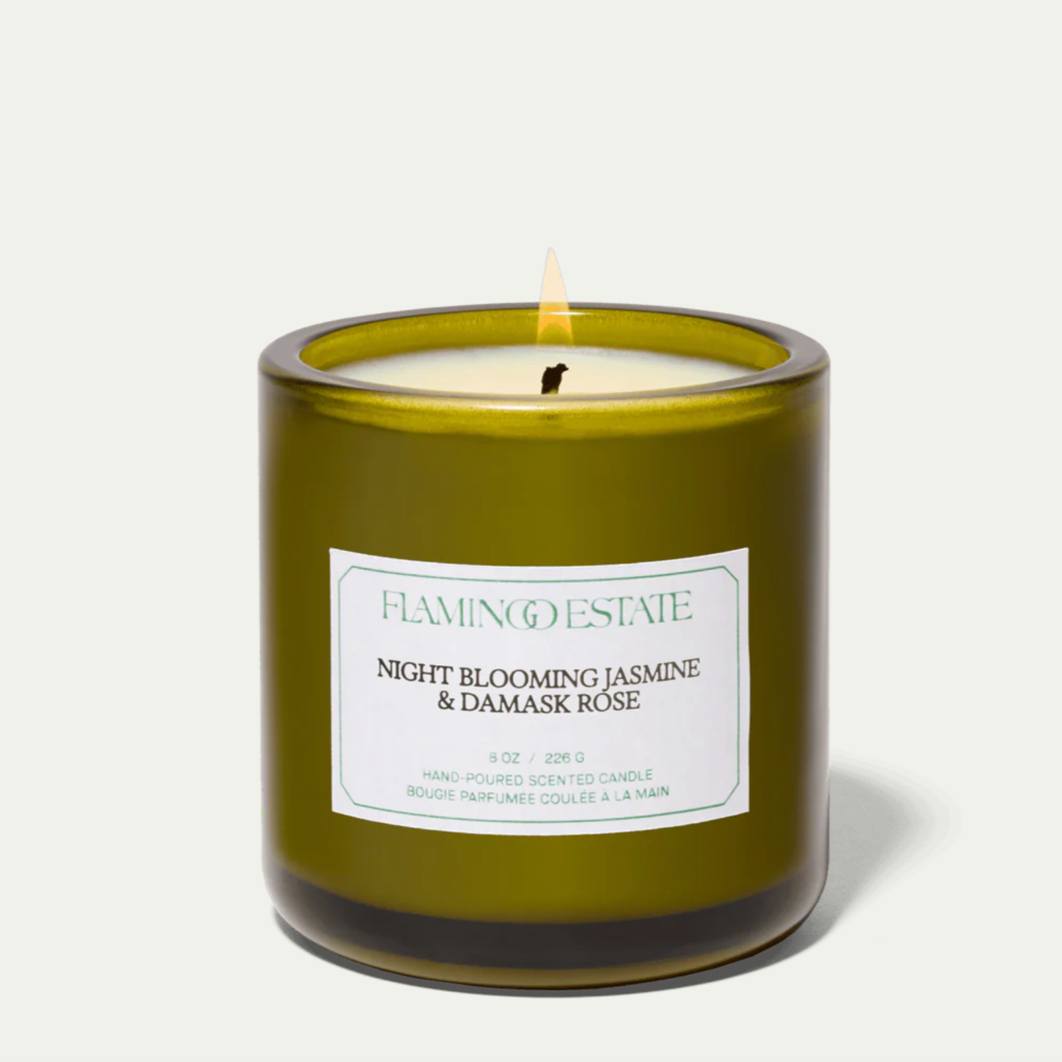 The Flamingo Estate night blooming jasmine and damask rose candle, in a green glass vessel