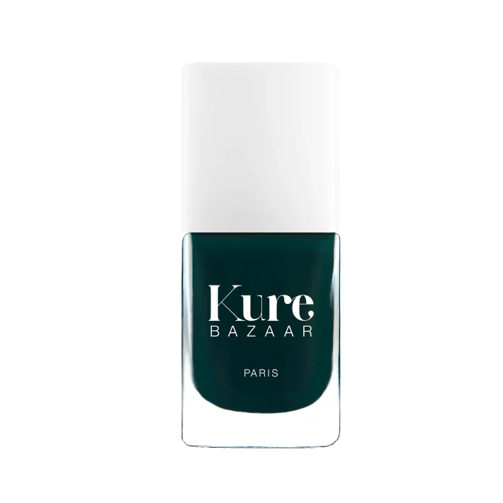 A bottle of Kure Bazaar nail polish in a deep green shade with a clear cap, labeled in Paris.