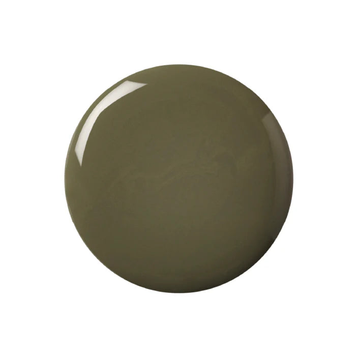 A bottle of Kure Bazaar nail polish in a khaki green shade with a white cap, labeled in Paris.