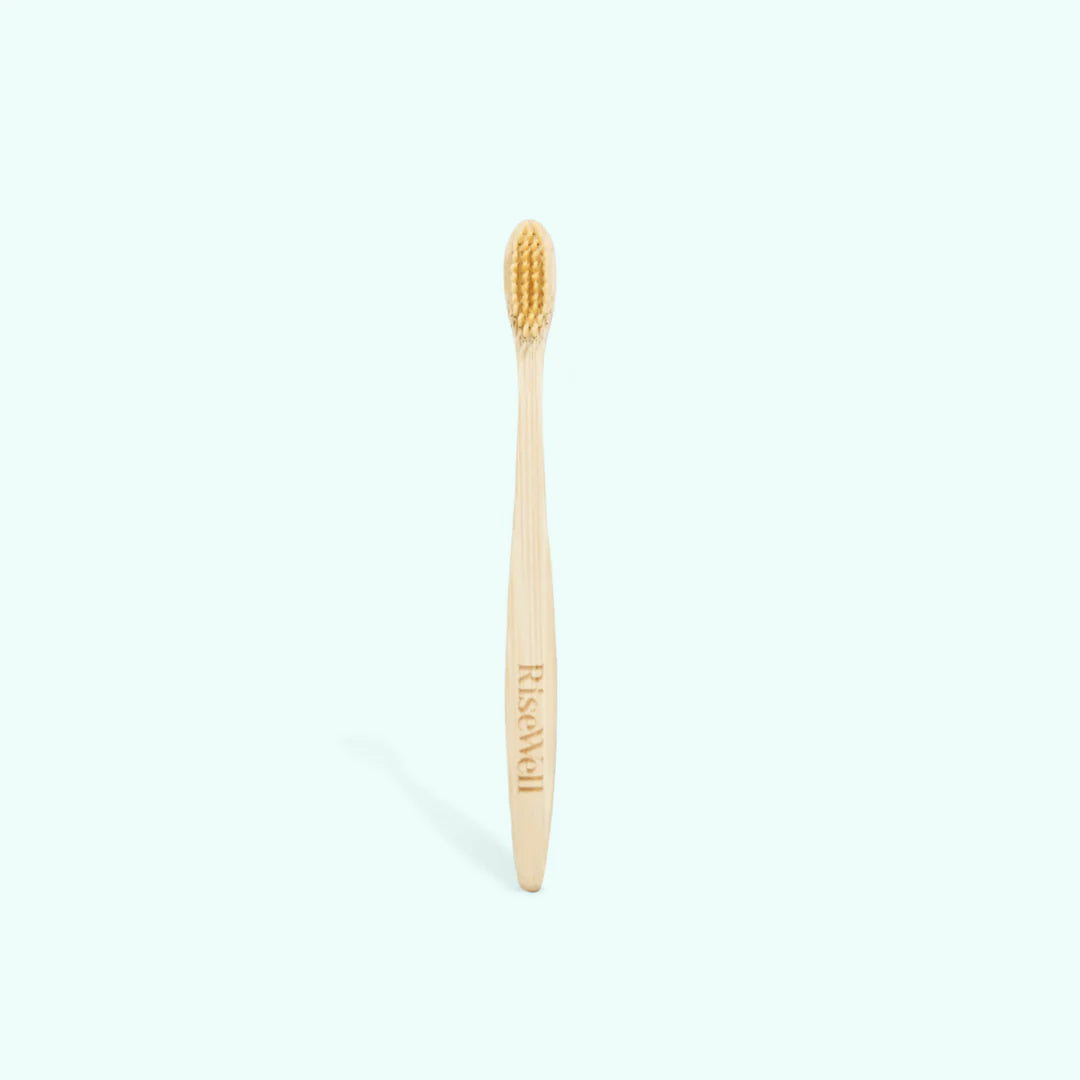 Bamboo toothbrush with 'Riswach' branding on a white background