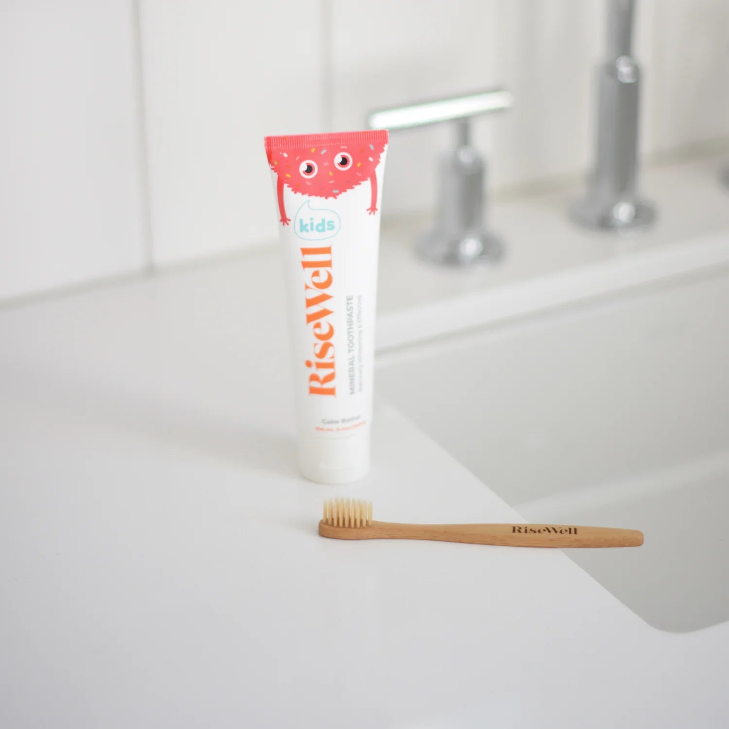 Bamboo toothbrush with 'Riswach' branding on a white background