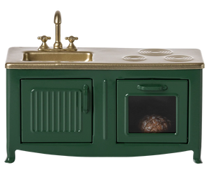 A dark green toy kitchen with a sink, oven, and cabinets, featuring a gold-colored faucet and black accents.