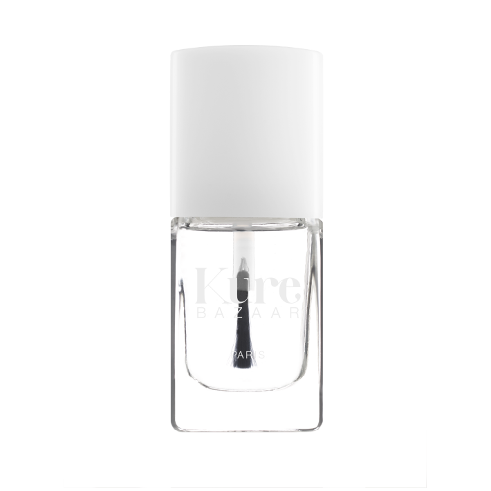Clear nail polish bottle with white cap on a white background