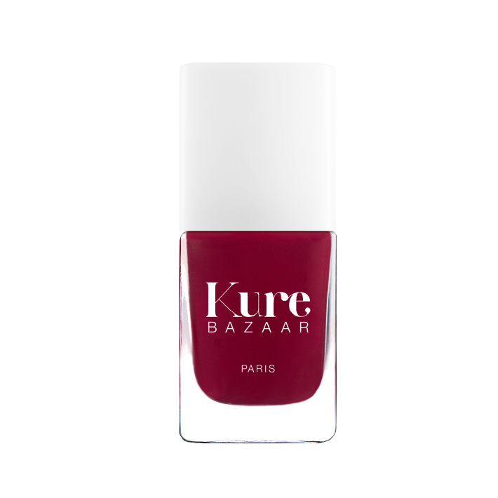 Red nail polish bottle with 'Kure Bazaar' branding on a white background