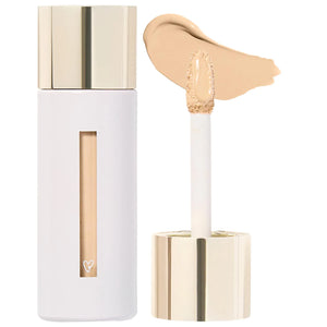 Cosmetic concealer with applicator and swatch on a white background