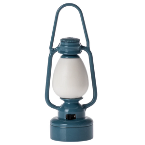 A small, blue metal lantern with a white lampshade, designed for toy mice.