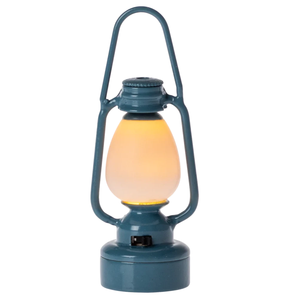 Blue lantern with a glowing yellow light on a white background
