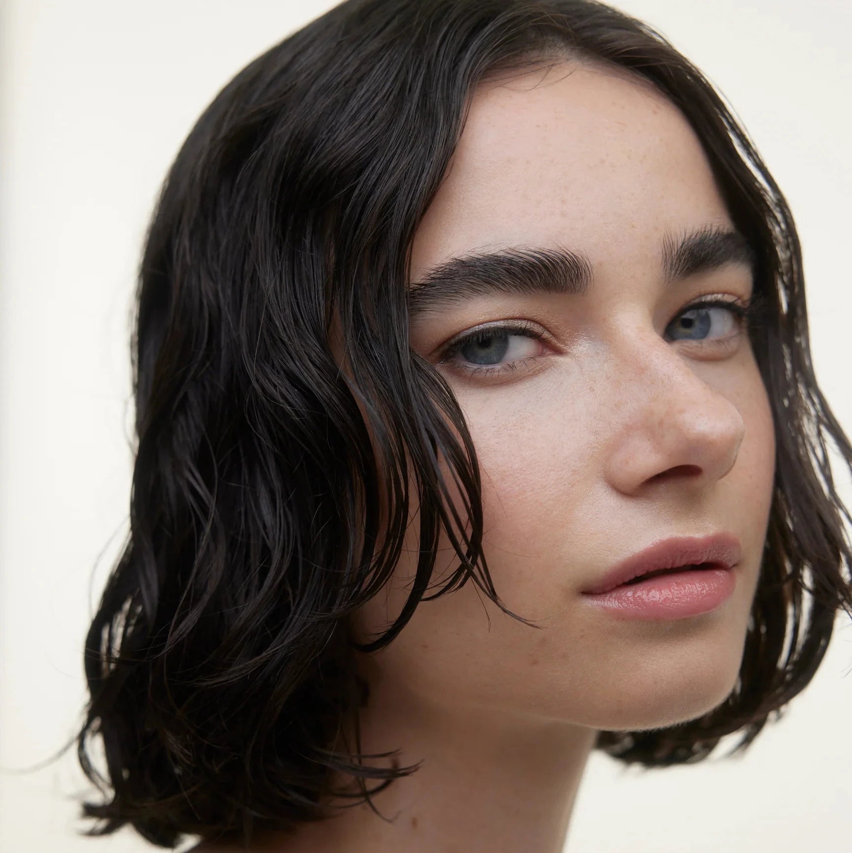 A woman with short, dark hair wearing the Le Regarde eye trio, made by Wonderblush in Montreal