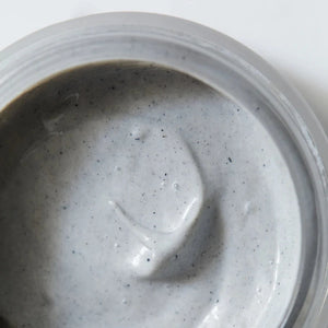 A close-up of an open container of bioactive mask