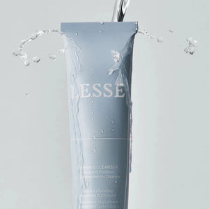 A tube of Lesse refining cleanser with water poured over the tube
