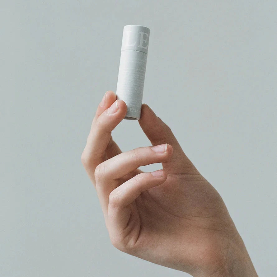 A tube of Lesse soothing lip balm, in a light grey tube with white writing