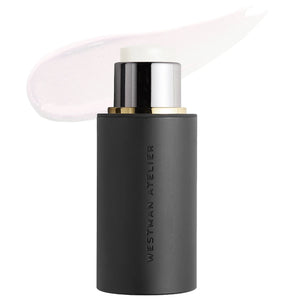 A black bottle of Westman Atelier Liquid Super Loaded Tinted Highlighter with its cap removed, showing a small amount of product on a white background.