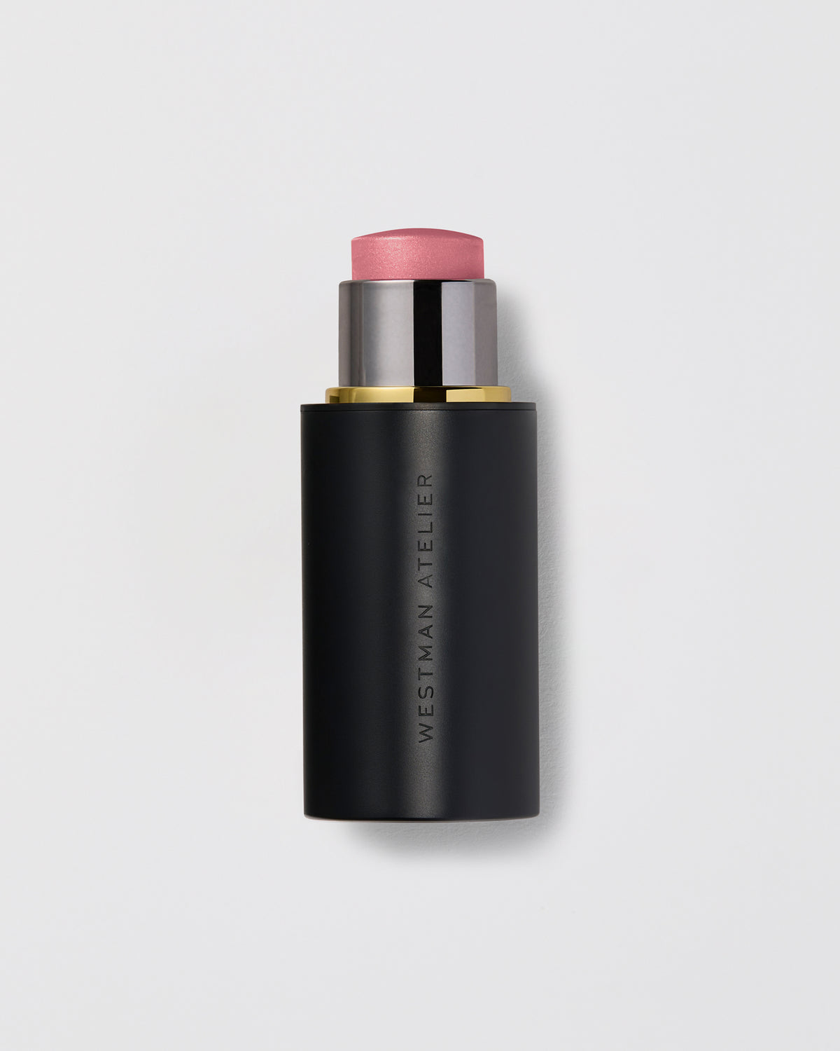A lit up highlight stick with a black casing and a pinkish highlighting product visible at the top.