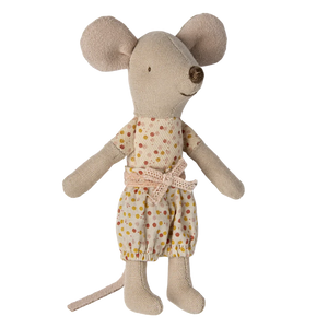Stuffed toy mouse wearing a polka dot outfit on a white background