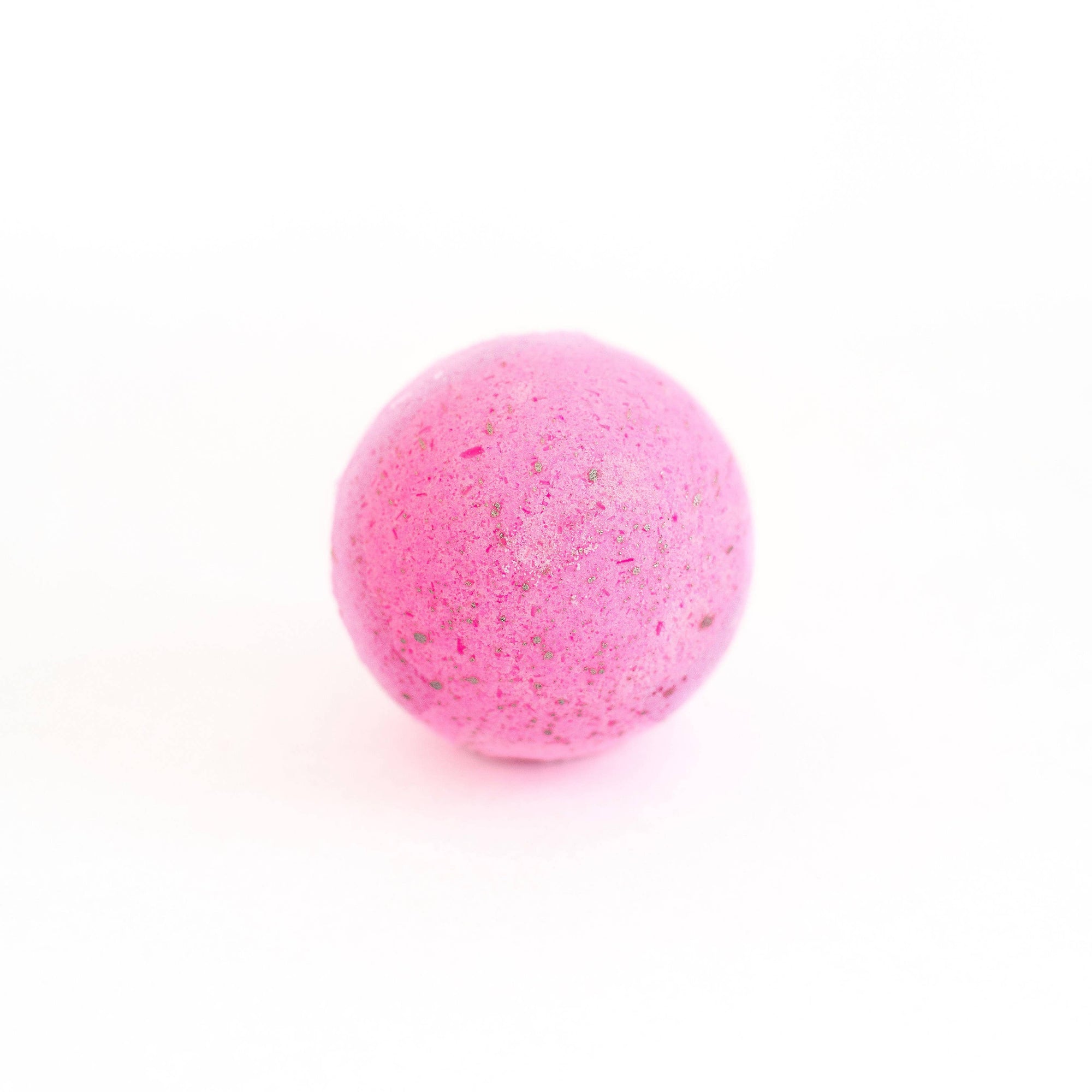 The soak love spell bath bomb is round and dark pink