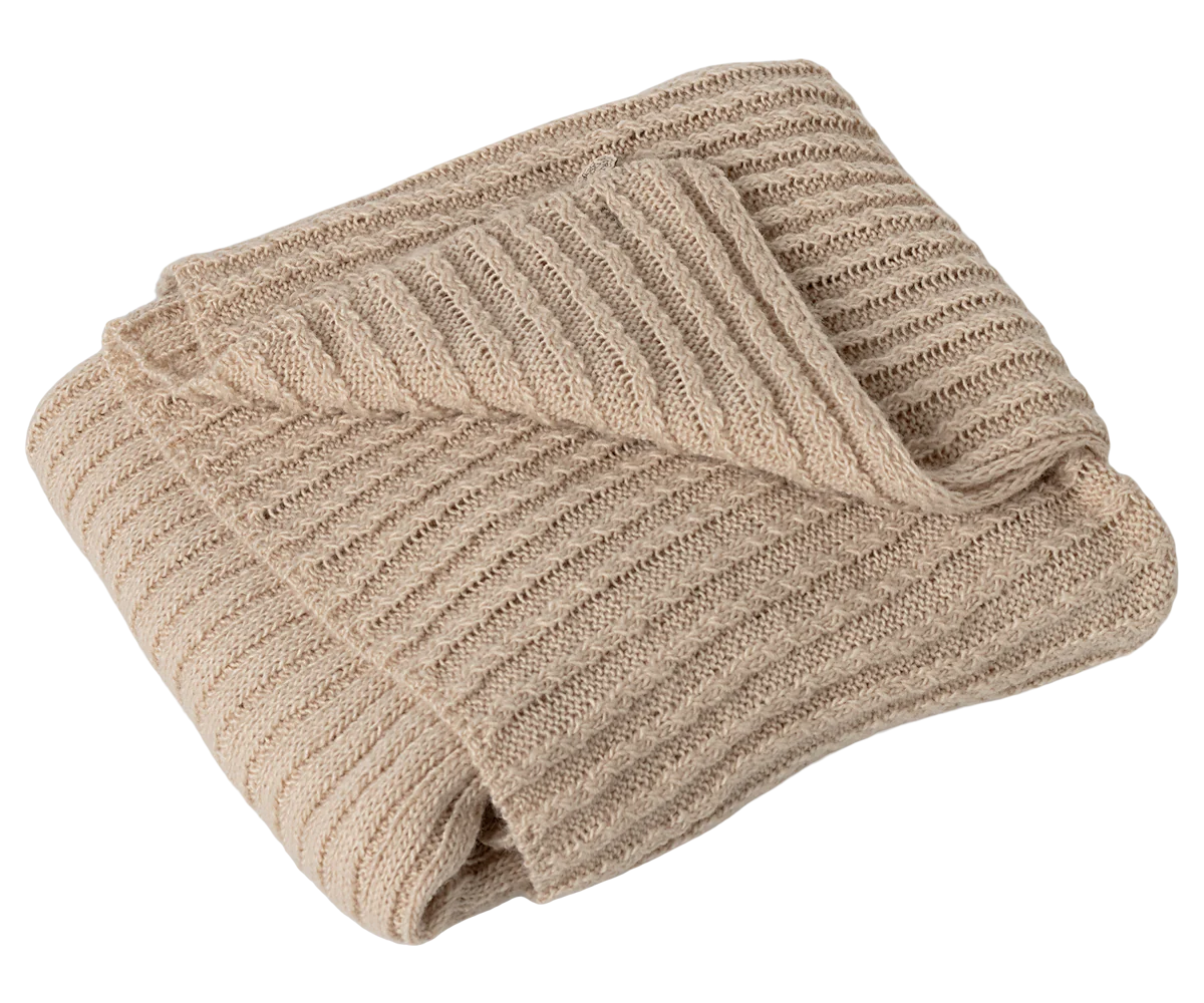 Beige knitted blanket on a white background