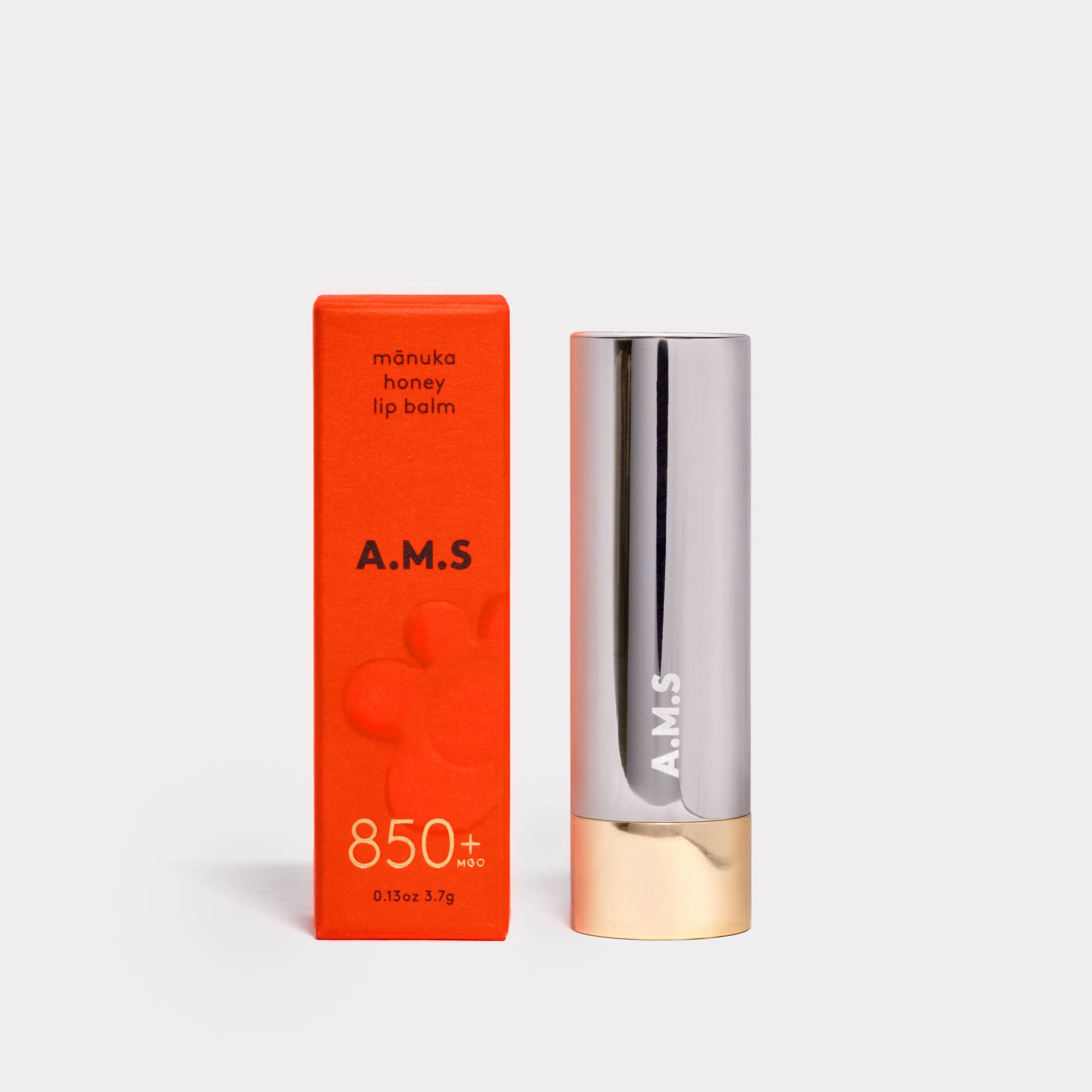 A.M.S lip balm with orange packaging on a white background