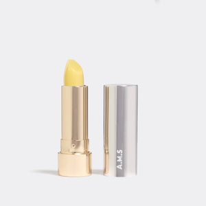 Yellow lipstick with silver case on a white background