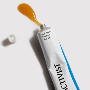 Tube of Activist manuka honey mask with a spoonful of honey on a white background