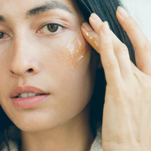 Woman applying a skincare product to her face