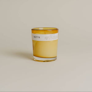 Candle with a label on a beige background