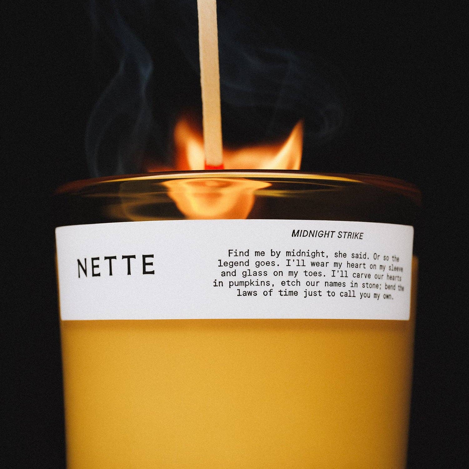 Candle with a label on a beige background