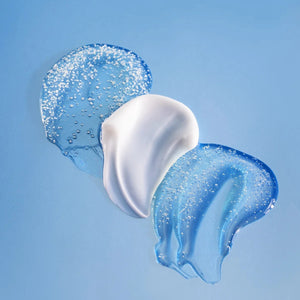 Three smears of white and blue cream against a light blue background