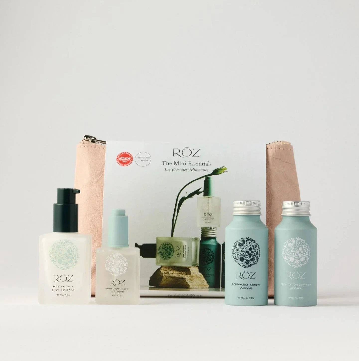 A ROZ Mini Essentials hair care kit with a pink bag.