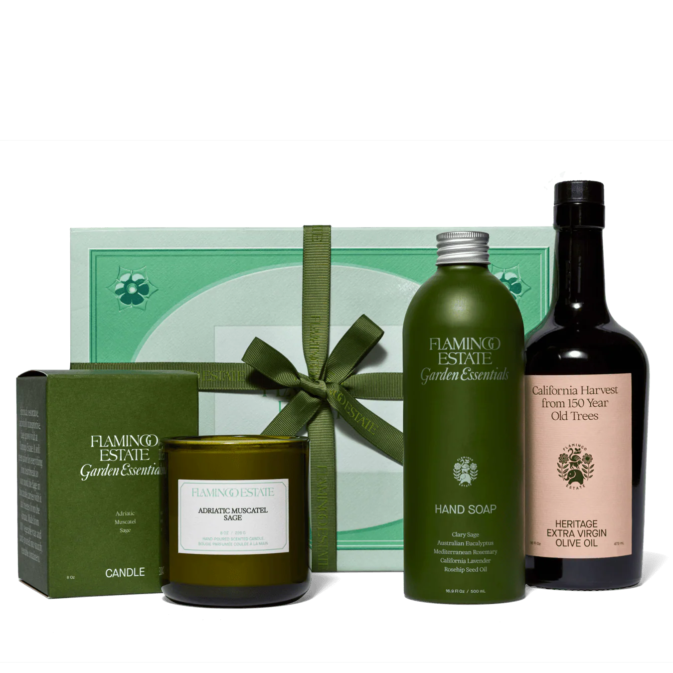 Flamingo Estate garden essentials including a candle, soap, and olive oil bottle on a white background.