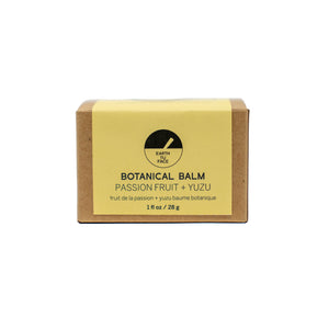 Botanical balm packaging with yellow label and brown box on a white background