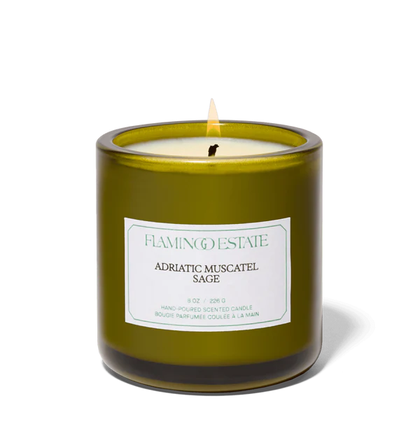 Green candle with a label on a white background