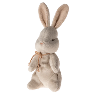Plush rabbit toy with a beige bow on a white background