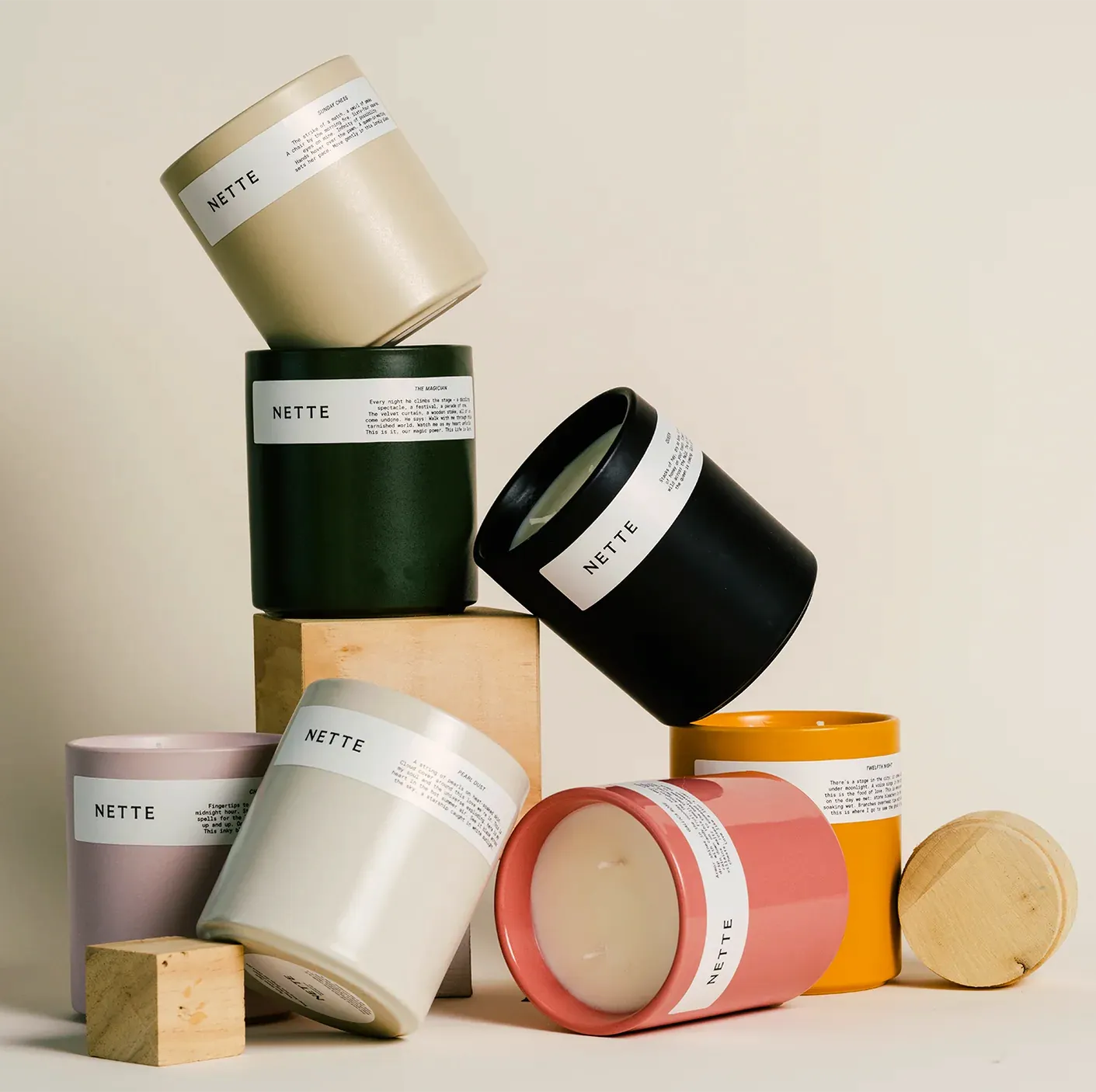 Stack of colorful 'NETTE' branded containers on a beige background