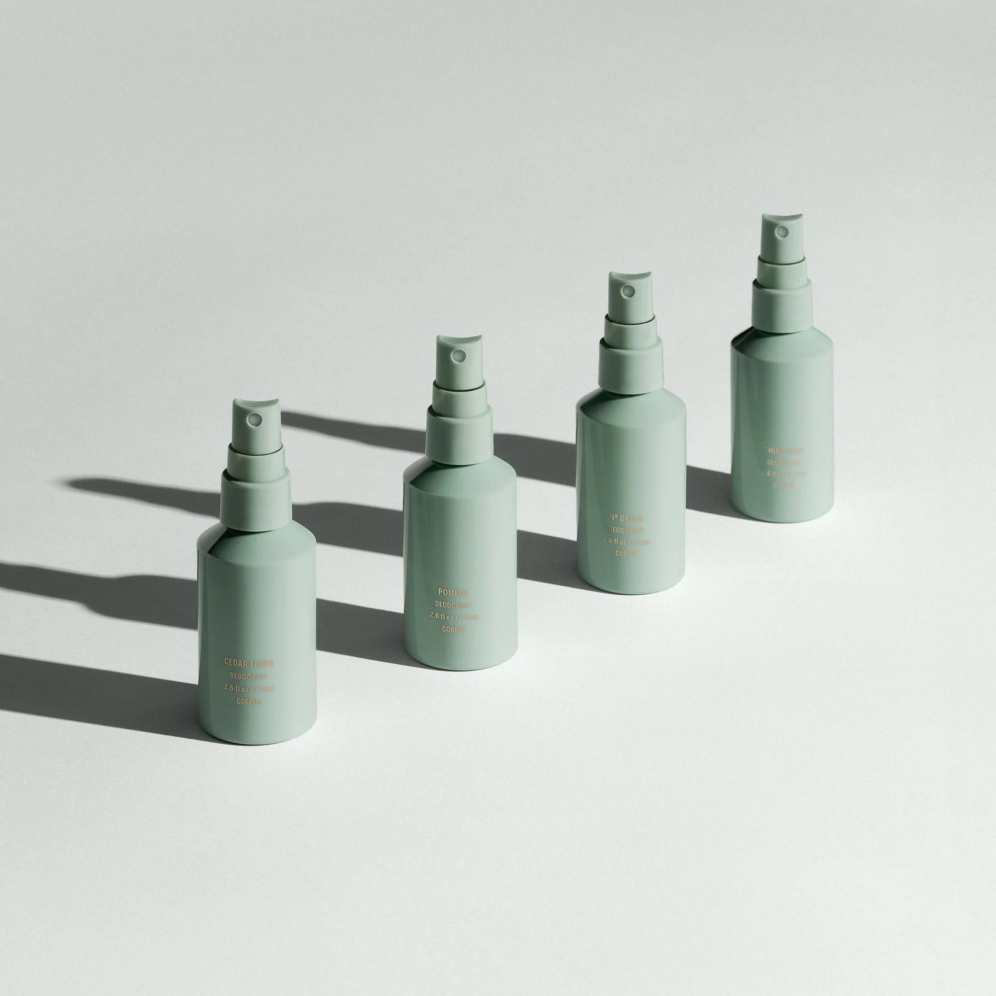 Four light green bottles lined up in a row