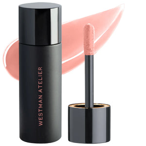 A photo of Westman Atelier Squeaky Clean Liquid Lip Balm with the container to the left and the applicator wand to the right, showing a translucent pink color.