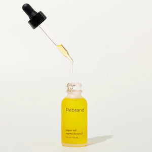 Yellow bottle of 'Rebrand' super oil with dropper on a white background