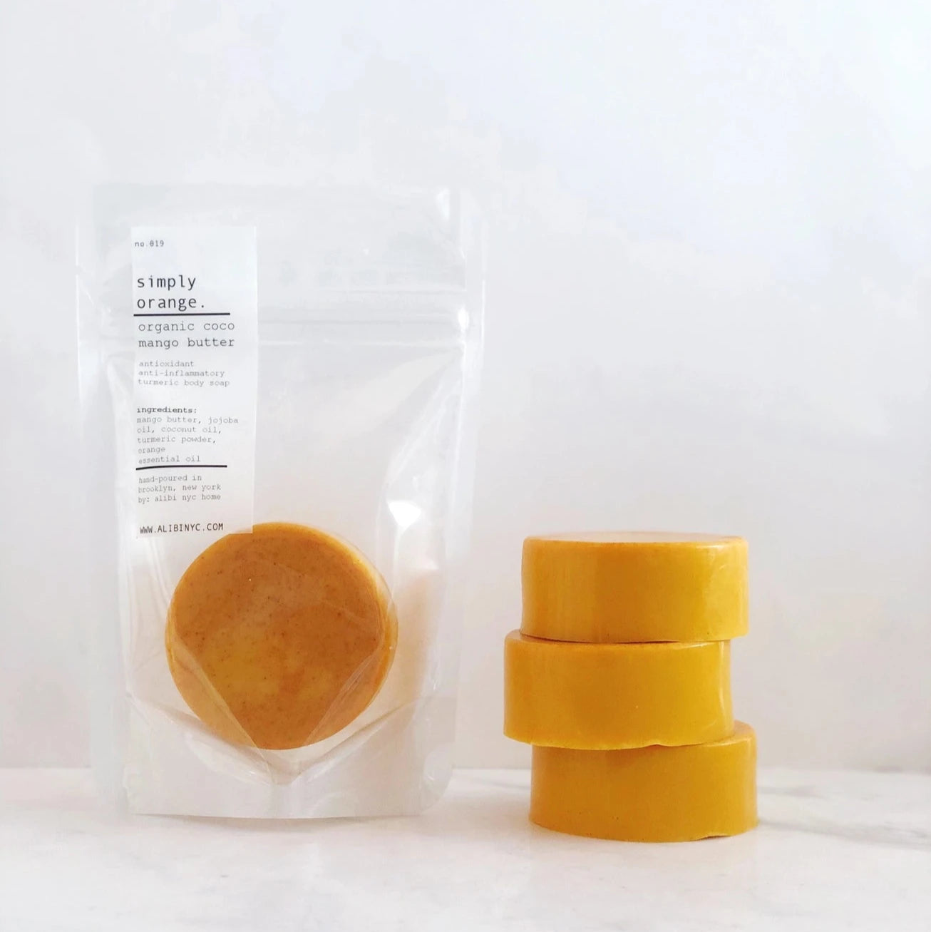 Three yellow circular objects on a marble surface with a white label.