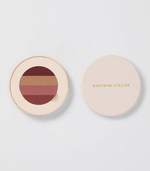 Makeup compact with color swatches and 'Westman Atelier' branding on a light background
