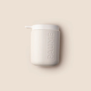 A white pump bottle with the brand name 'paume' printed on it, against a beige background.